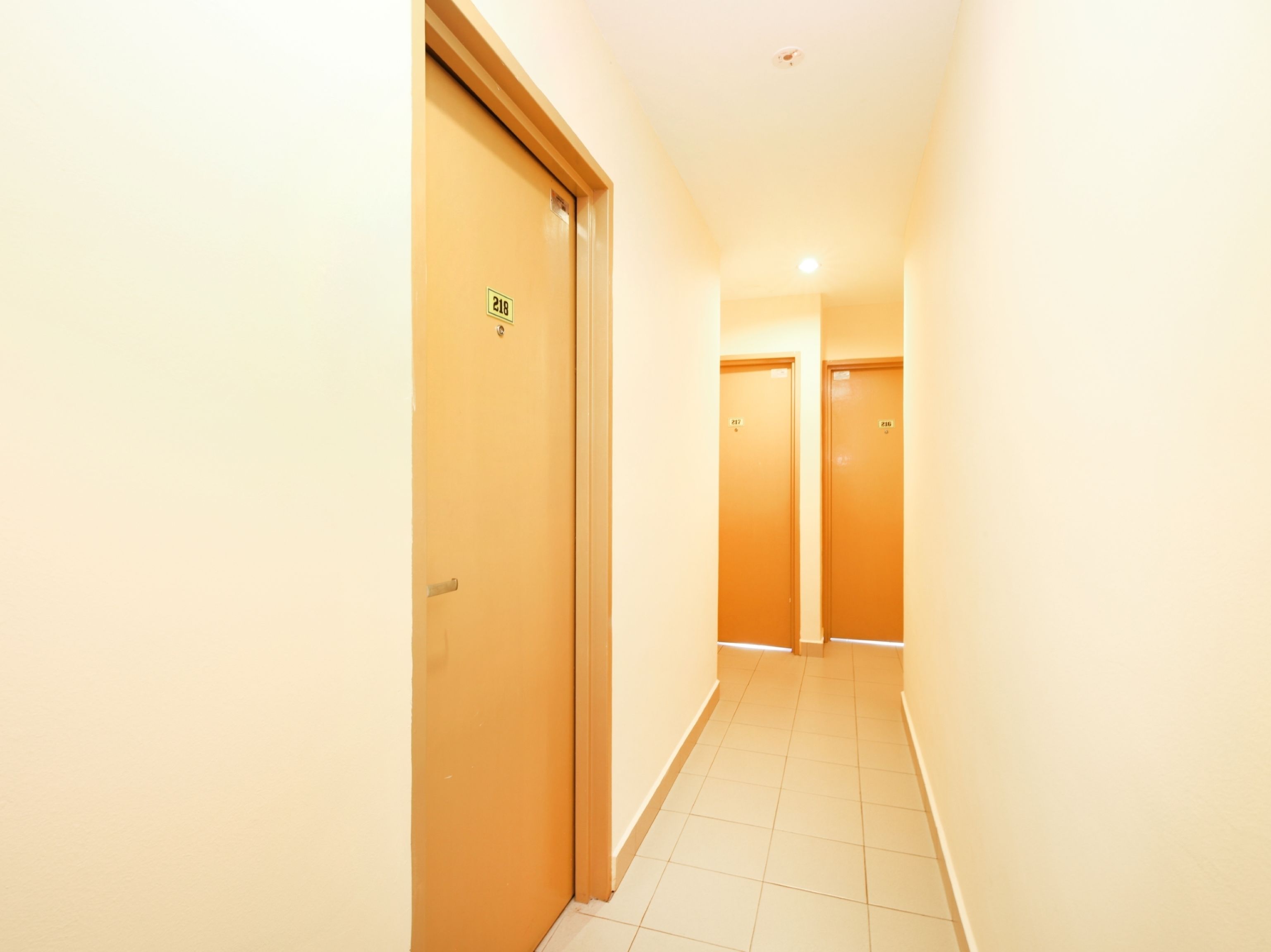 A narrow, well-lit hallway with doors numbered 218 and 217.