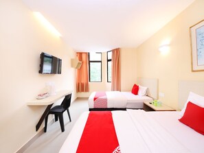 A hotel room with two beds, a desk, a chair, a TV, and a window with curtains.