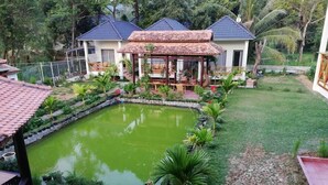 A house with a garden, a pond, and a gazebo. - Areca Garden Bungalow (Phu Quoc)
