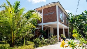 A two-story building with a sign reading "Areca Garden." - Areca Garden Bungalow (Phu Quoc)