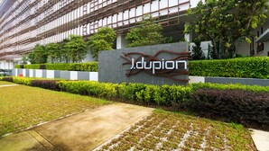 A modern building with a sign reading "Jdupion" surrounded by well-maintained greenery and a clear pathway. - J DUPION Boutique Suites by NowHere (Kuala Lumpur)