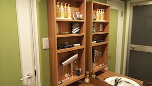 A bathroom with a wooden vanity, a sink, and shelves holding toiletries and hairdryers. - Hotel Xenia Amagasaki - Adult Only (Amagasaki)