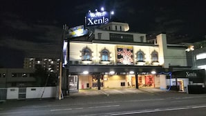 A hotel with a sign reading "Hotel Xena" and a large illuminated sign advertising room rates. - Hotel Xenia Amagasaki - Adult Only (Amagasaki)