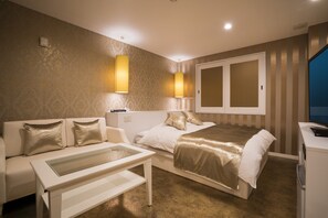 A hotel room with a bed, a sofa, a desk, and a television. - Hotel Xenia Amagasaki - Adult Only (Amagasaki)
