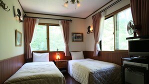 A room with two beds, a television, a heater, and a window with curtains. - Piccolo Hotel Opera Karuizawa (Karuizawa)