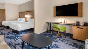 A hotel room with two beds, a desk, a chair, a TV, and a coffee maker. - Fairfield Inn & Suites by Marriott Helen (Helen)
