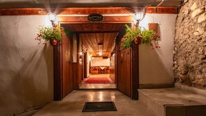 A hallway with wooden doors and a red carpet leading to a room. - Beyzade Konak Otel (Safranbolu)