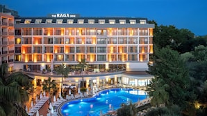 A hotel with multiple floors, a swimming pool, and outdoor seating areas. - The Raga Side - Adults Only - All inclusive (Manavgat)