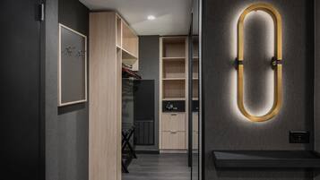 A modern interior with a wooden wardrobe, a built-in bench, and a wall-mounted light fixture.