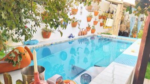 A swimming pool with tiled edges and a tiled deck area.