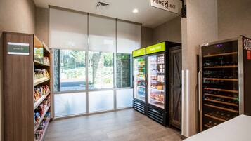 A modern interior with a 'MARKET' section, a 'HOME2MKT' sign, and a wine cooler.
