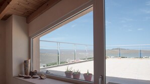 Balkon med udsigt over en parkeringsplads og fjerne bjerge.