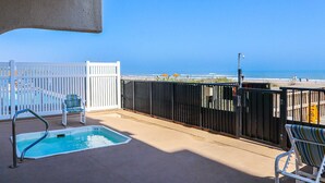 A balcony with a pool, white railing, and a view of the beach. - Florence I 307 Minium 1 Bedroom Condo by RedAwning (South Padre Island)