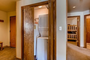 Enter a warm and inviting hallway leading to a convenient laundry area with a washer and dryer.
