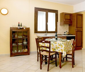Full-sized fridge, stovetop, cookware/dishes/utensils