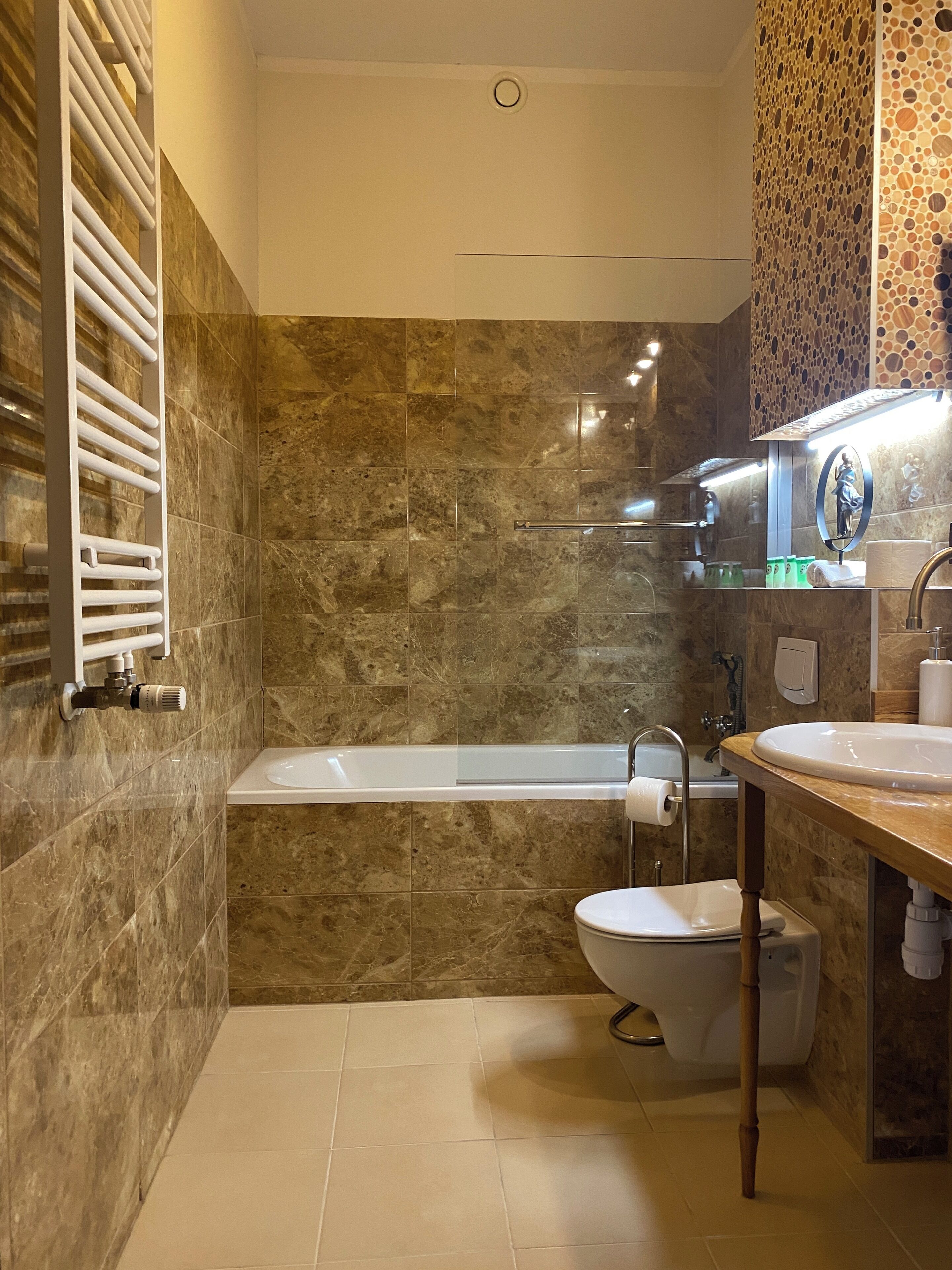 A modern bathroom with a bathtub, toilet, and sink.