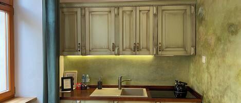 A kitchen with wooden cabinets, a sink, and a countertop.