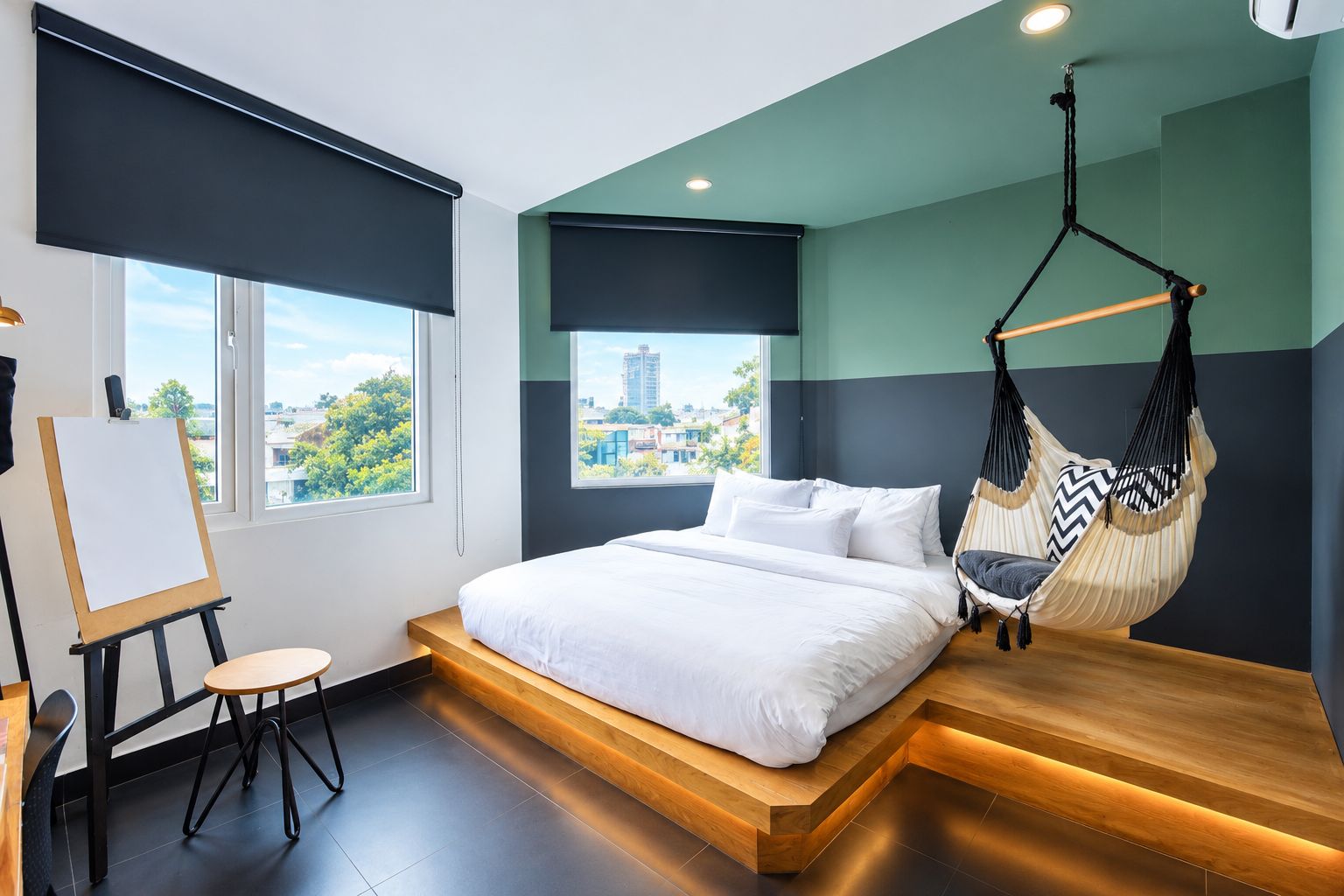 A modern bedroom with a bed, a hammock chair, and a view of the city.