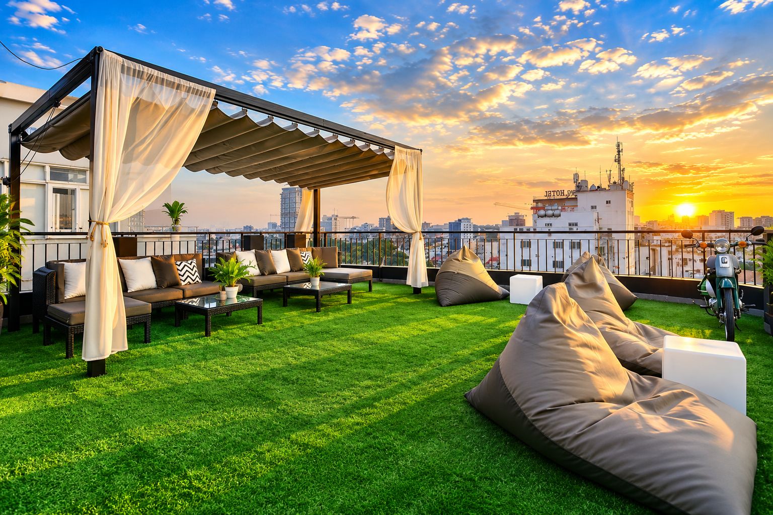 A rooftop terrace with a covered seating area, green artificial grass, and a sunset view.