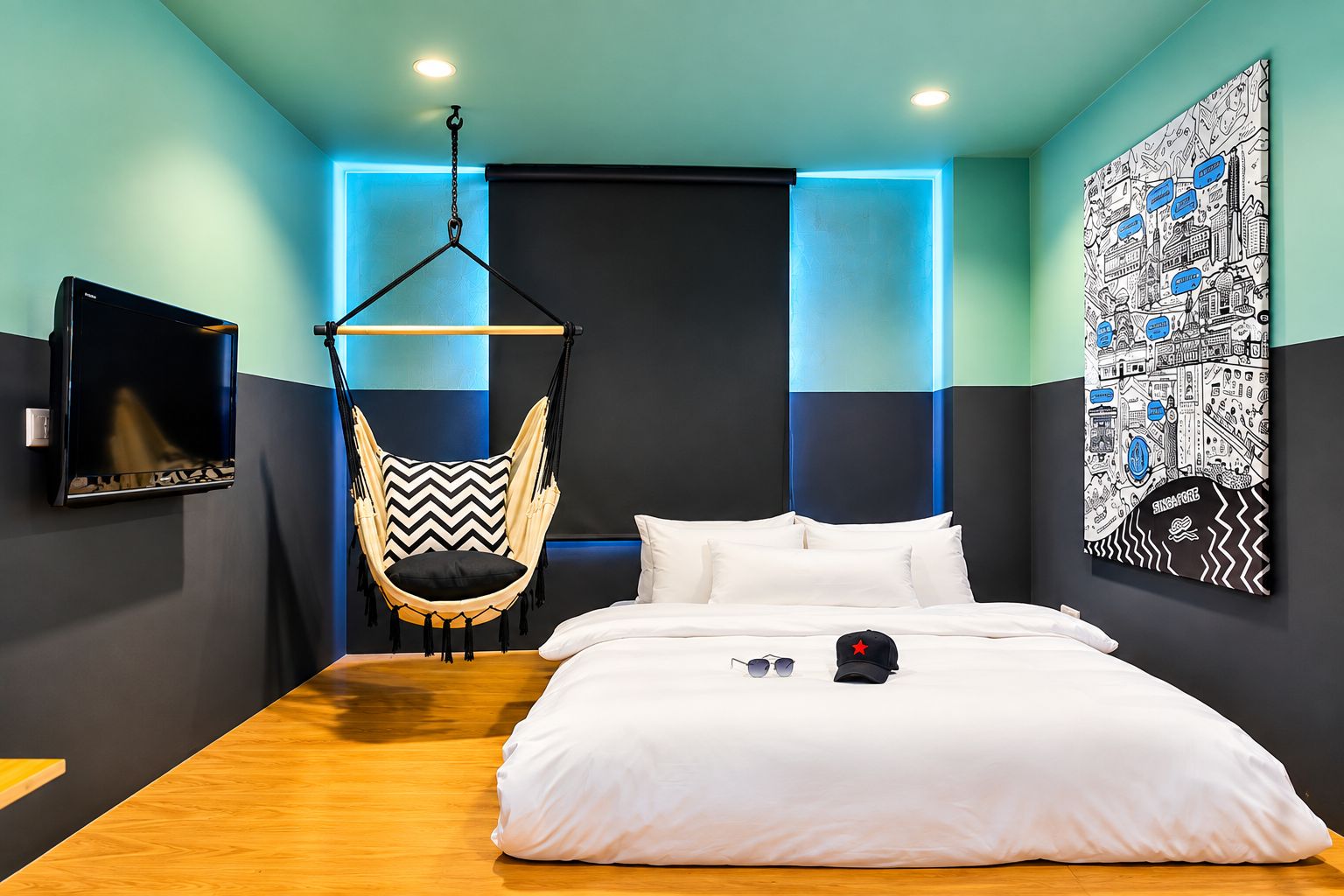 A modern bedroom with a bed, a hanging chair, a wall-mounted TV, and a cityscape artwork.