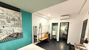 A hotel room with a bed, a desk, a mirror, and a wall map. - The Hammock Hotel Fine Arts Museum (Ho Chi Minh City)