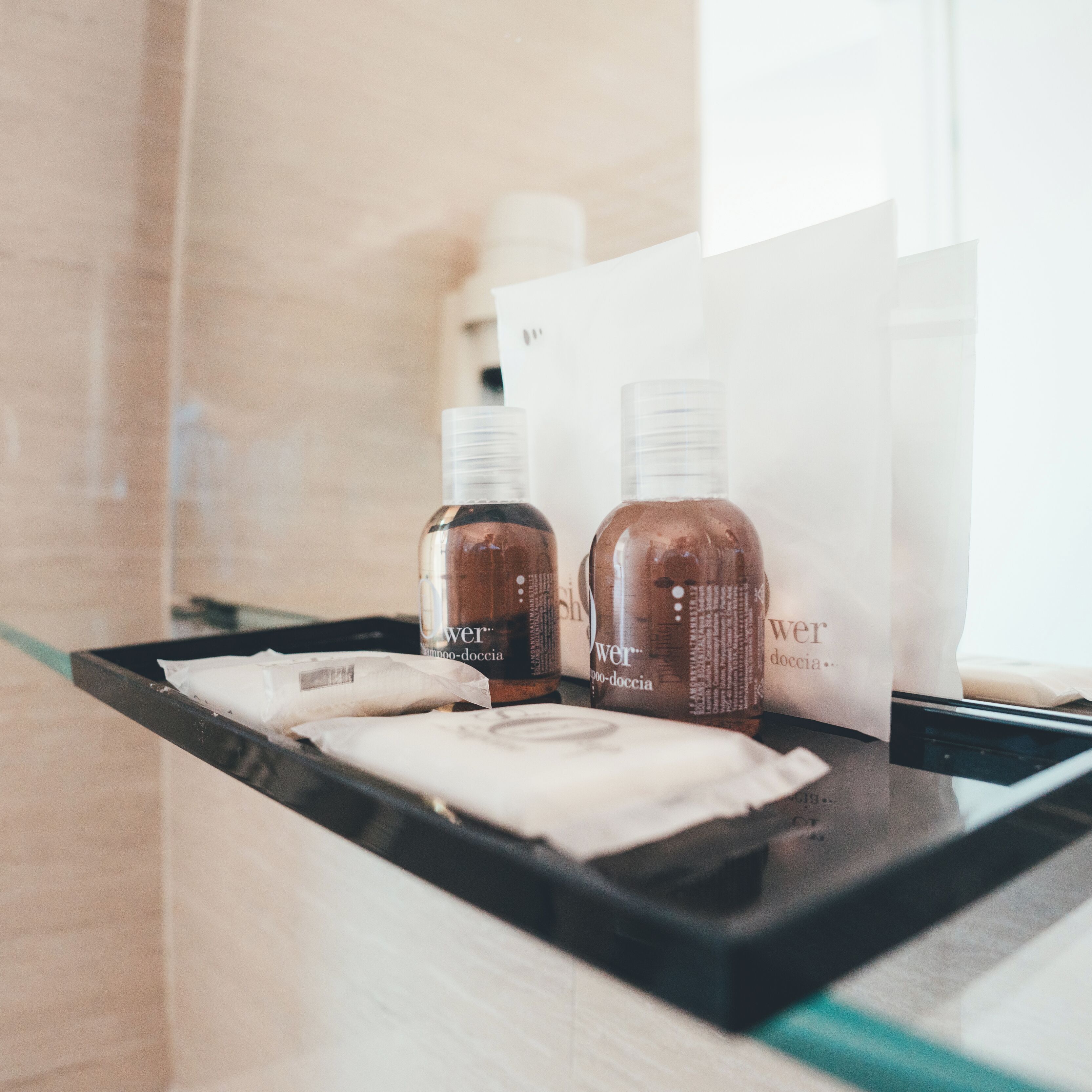 A counter with two bottles of hair product and a white box with text.