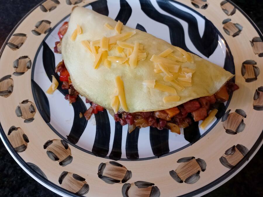 A sandwich on a plate with a patterned design.