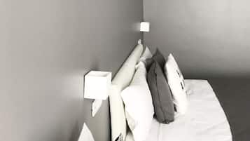 Una camera da letto moderna con un letto ben rifatto, un comodino e una lampada a parete.