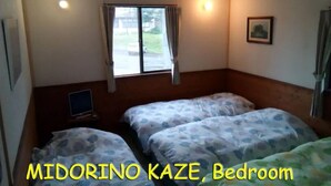 A bedroom with two beds, a window, a bedside table, and a picture on the wall. - Rental Lodge WHITE RABBIT Madarao kogen Cottage MIDORINO KAZE (Iiyama)