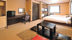 A hotel room with a bed, a desk with a television, a chair, a small table, and a window. - Condominium Hotel Naeba West (Yuzawa)