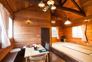 Traditional Japanese-style room with tatami mat floor, low wooden table, and seating area.