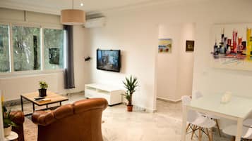 Design Apartment, 3 Bedrooms, Non Smoking, Hill View | Living area | 49-inch flat-screen TV with cable channels, TV