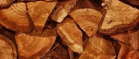 A close-up of stacked firewood logs.