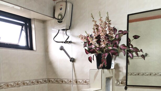 A bathroom with a bathtub, a sink, a mirror, and a hand dryer. - Tabaco Gardenia Hotel (Tabaco City)
