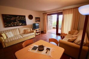 House, 1 Bedroom, Sea View | Living area | Flat-screen TV - Casa Marinella (Olbia)