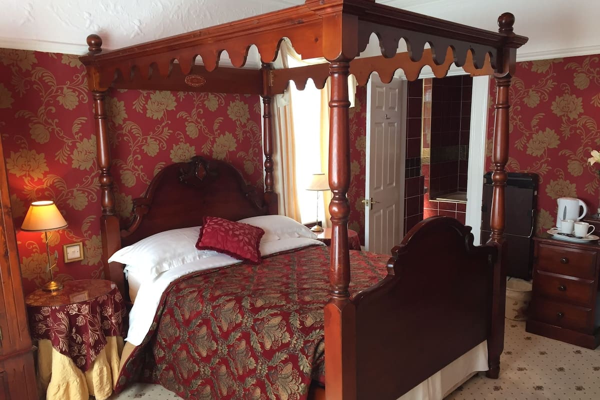 Desk, iron/ironing board, bed sheets