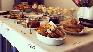 A buffet table with various food items and a blue cabinet in the background.