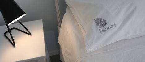 Ein ordentlich bezogenes Bett mit einem Kissen, bestickt mit "Paddere43".