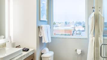 A modern bathroom with a toilet, sink, and shower.