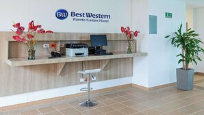 A reception desk at Best Western Puerto Gaitan Hotel with a computer, printer, and phone.