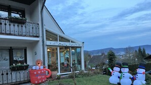 A building with a glass entrance, a red hot tub, and snowman decorations.