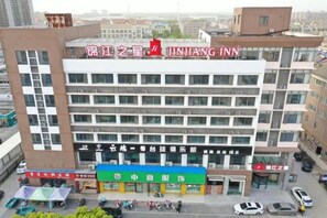 A multi-story hotel with a prominent signage for 'JINJIANG INN' at the top. - Jinjiang Inn Huai'an Development Zone (Huai'an)