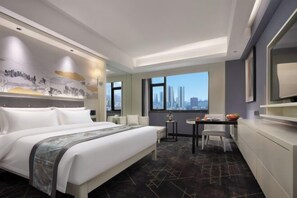 A modern hotel room with a large bed, a dining area, and a city view. - Shenzhou Mingzhu Hotel (Leiyang)