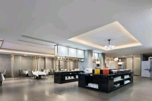 A modern hotel lobby with a reception desk, seating area, and a large window. - Shenzhou Mingzhu Hotel (Leiyang)