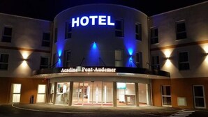 Un hotel con un cartel grande que dice 'HOTEL' y el nombre 'Acadine Pont-Audemer'.