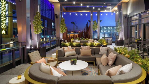 A modern lounge area with a sectional sofa, round coffee table, and various seating options. - Hyatt Place Indianapolis Downtown (Indianapolis)