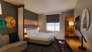 A hotel room with a bed, a sofa, a desk, and a TV.