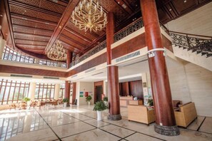 A spacious lobby with high ceilings, large wooden columns, and a grand chandelier. - Ningguo Wooden Villa of the World (Ningguo)