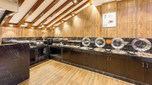 A buffet area with a marble countertop, wooden ceiling beams, and a tiled wall. - Junlin Four Seasons Hotel (ZHEJIANG)