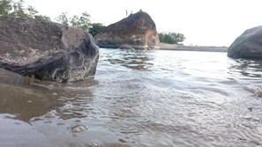 A natural rock formation by a body of water. - Hosteria Piedra De Vapor (Puerto Quito)